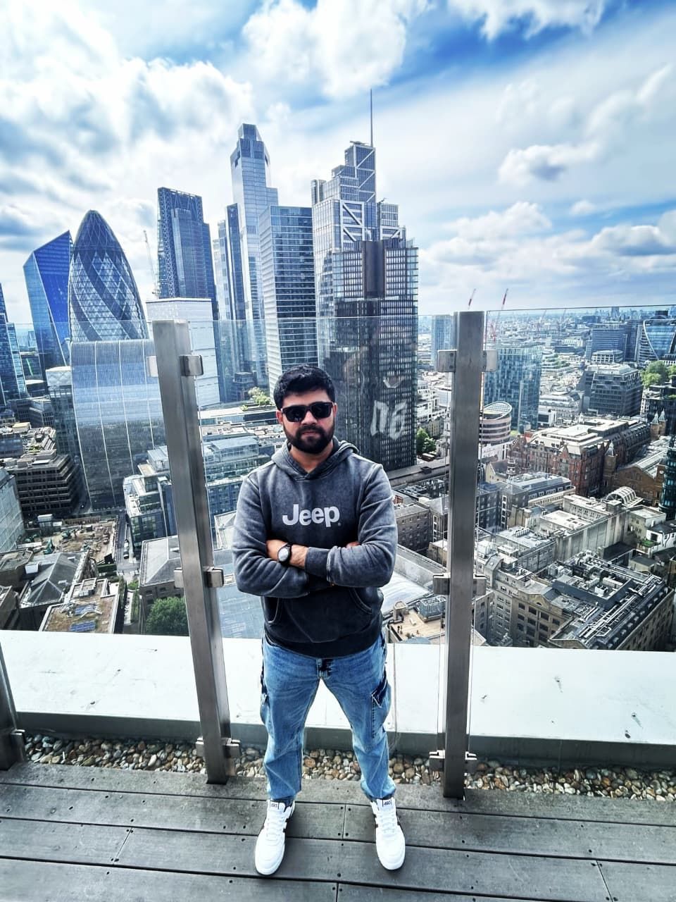 Malav Naik on a rooftop with a city skyline behind – Migrating On-Prem SQL Server to Azure SQL PaaS: How We Cut Infrastructure Costs by 25%