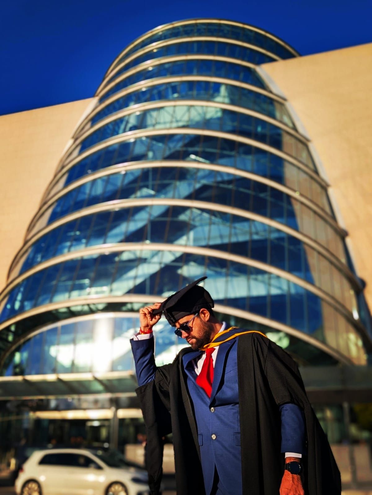 Malav Naik in graduation gown outside a glass building in Dublin – From Surat to Dublin: 10 Years in Data, and Why I'm Just Getting Started