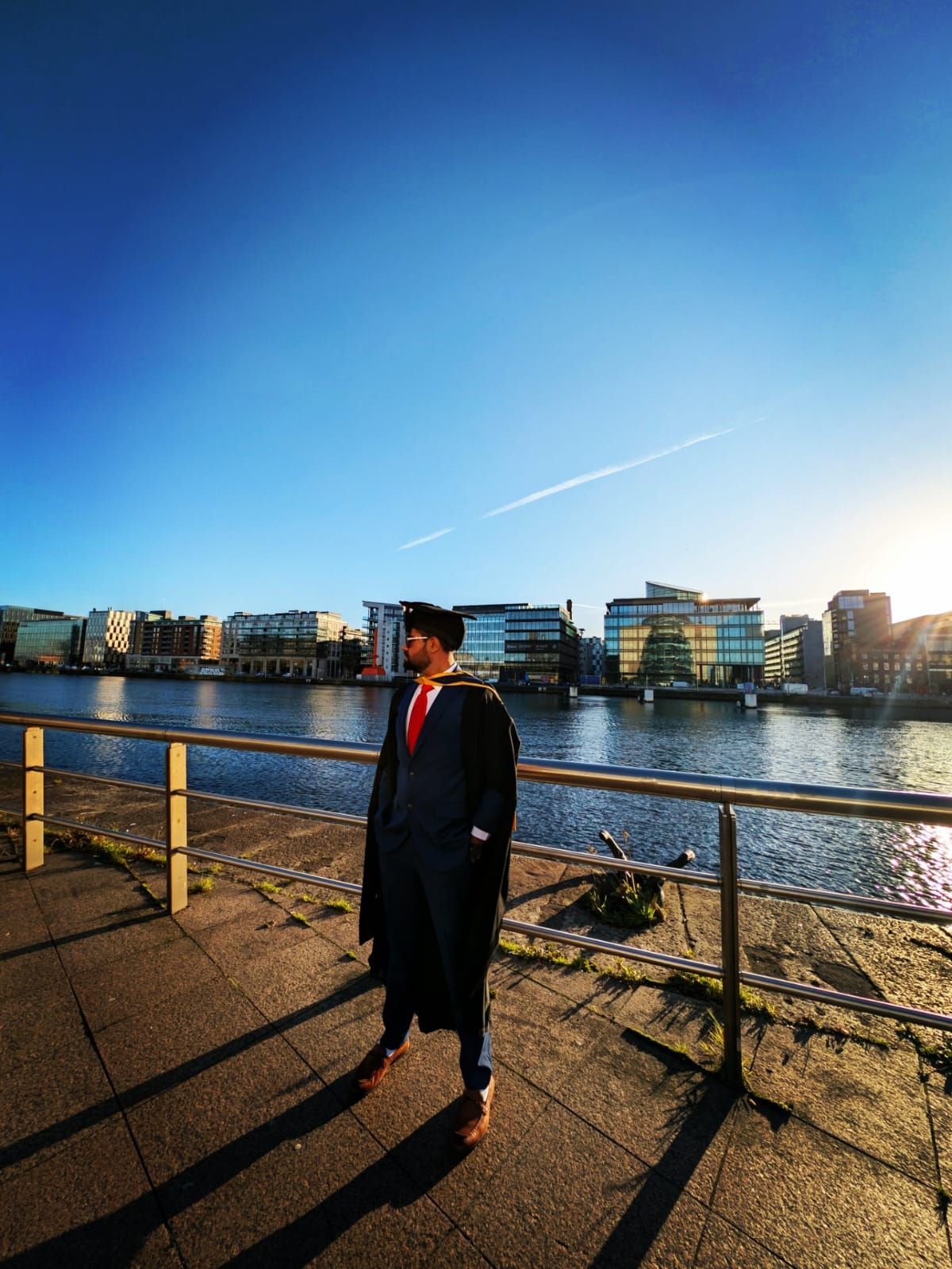 Malav Naik in a graduation gown by the River Liffey – What a Master's in Ireland Taught Me After Nine Years in Industry