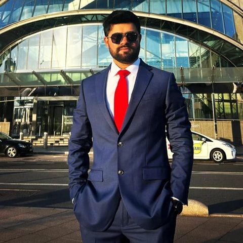 Malav Naik in a navy suit outside the Convention Centre Dublin